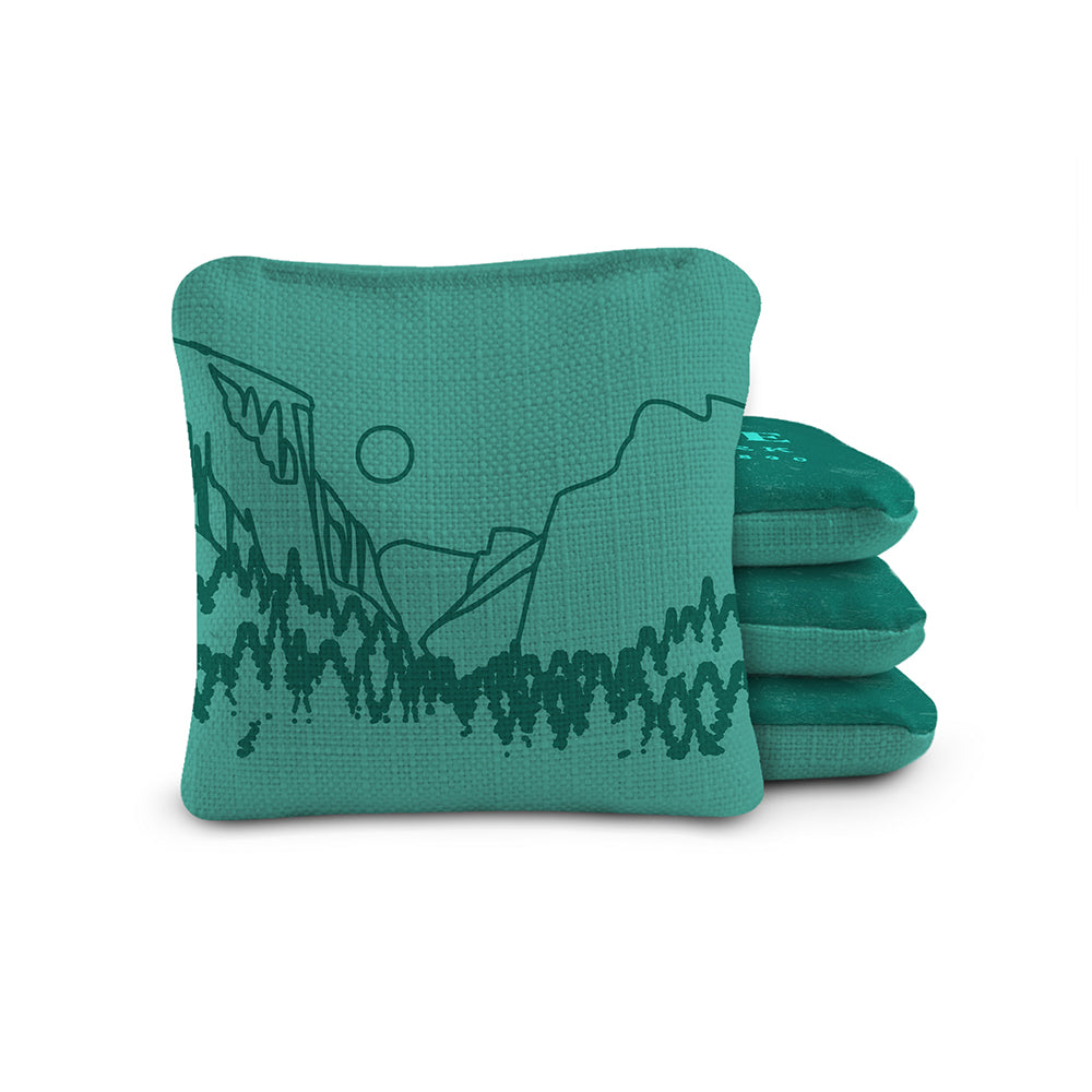 Teal bean bag with mountain design on a white background