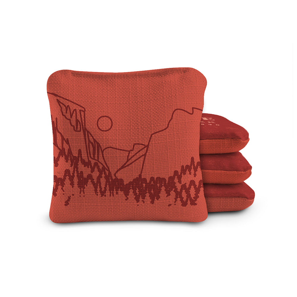 Red bean bags with mountain design on a white background
