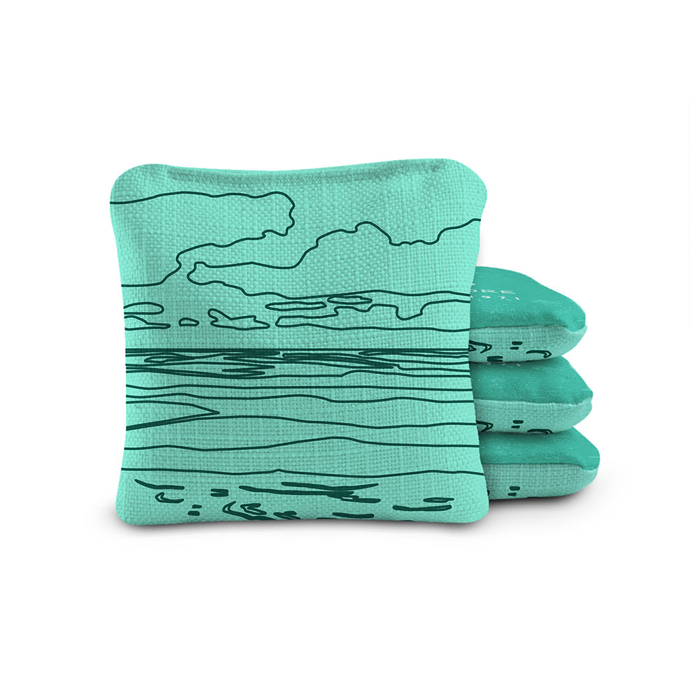 Stack of teal socks with black line pattern on a white background