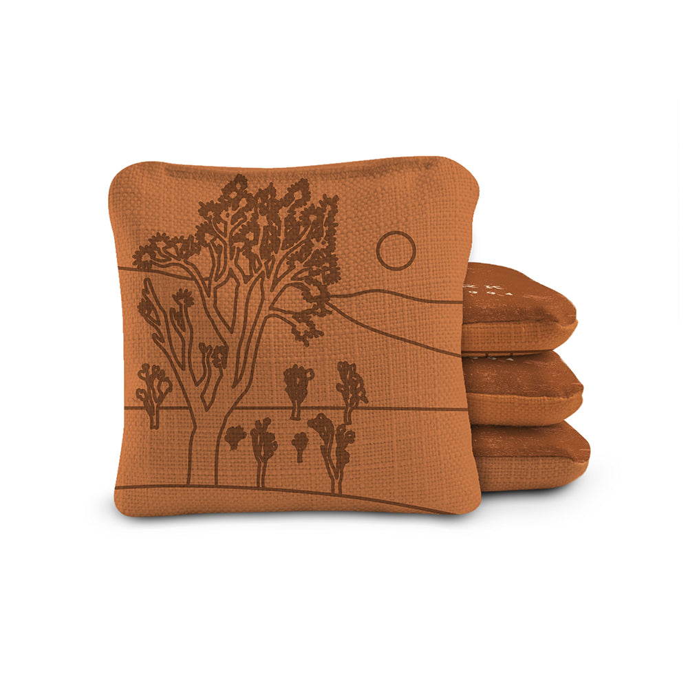 Stack of brown fabric items with nature-themed design on a white background