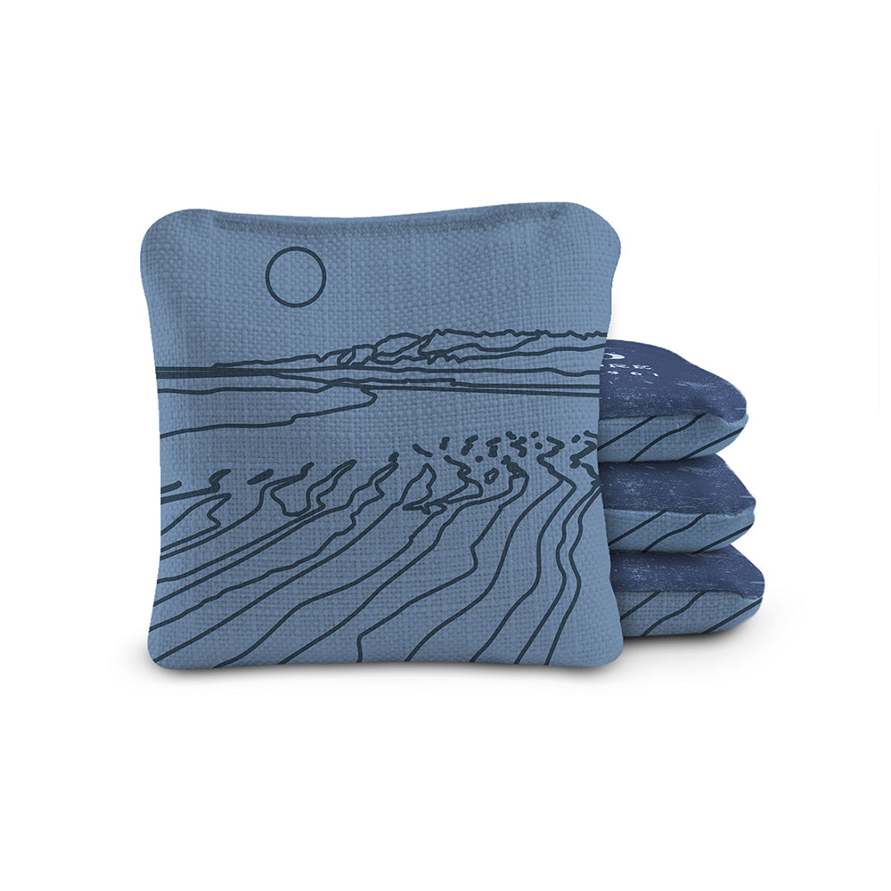 Set of blue coasters with a landscape design on a white background