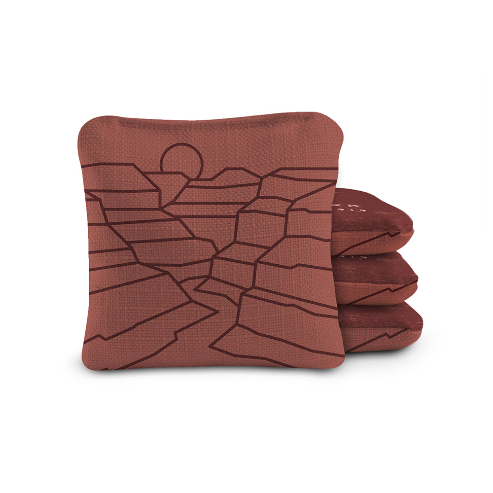 Folded brown towel with geometric pattern on a white background
