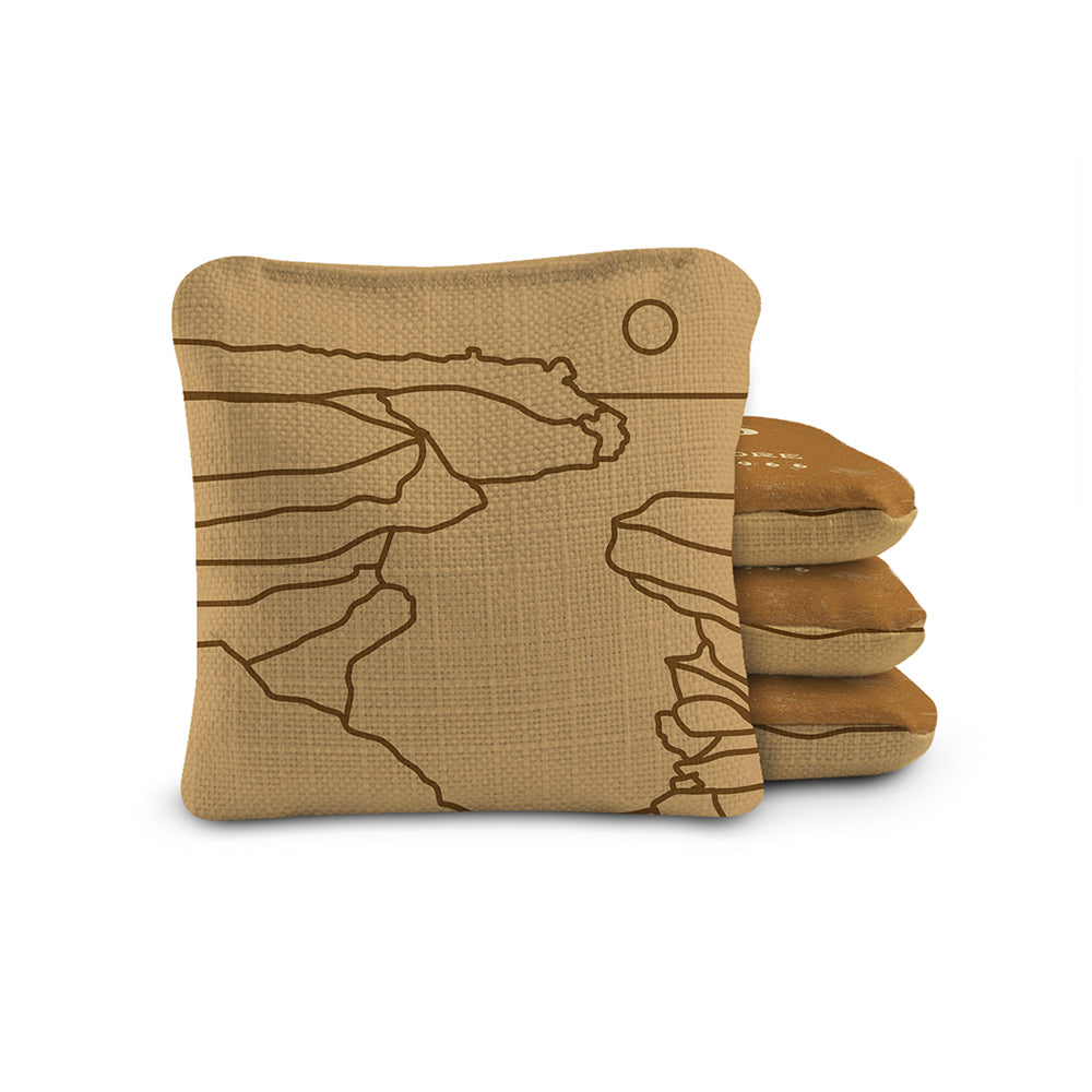 Stack of brown paper bags with a geometric design on a white background