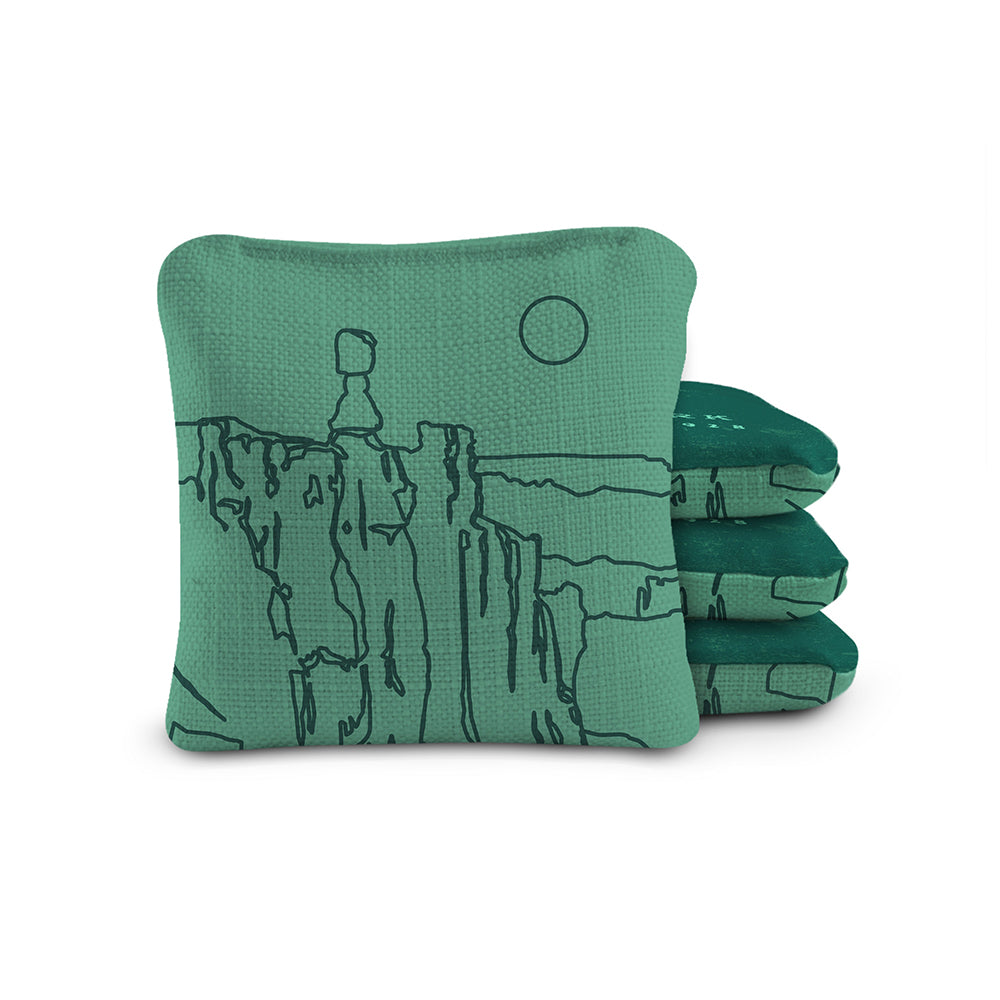 Green bean bag with mountain design on a white background