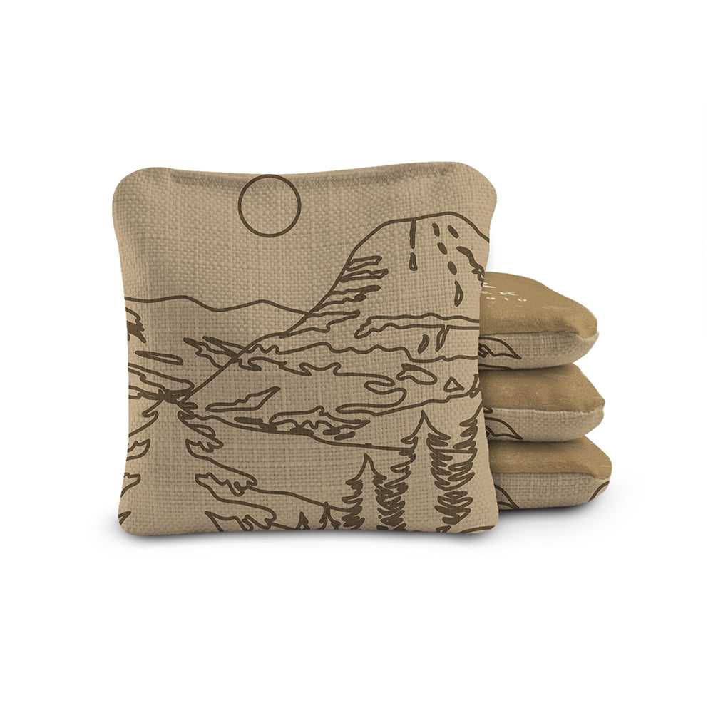 Set of cornhole bags with nature-themed design on a white background