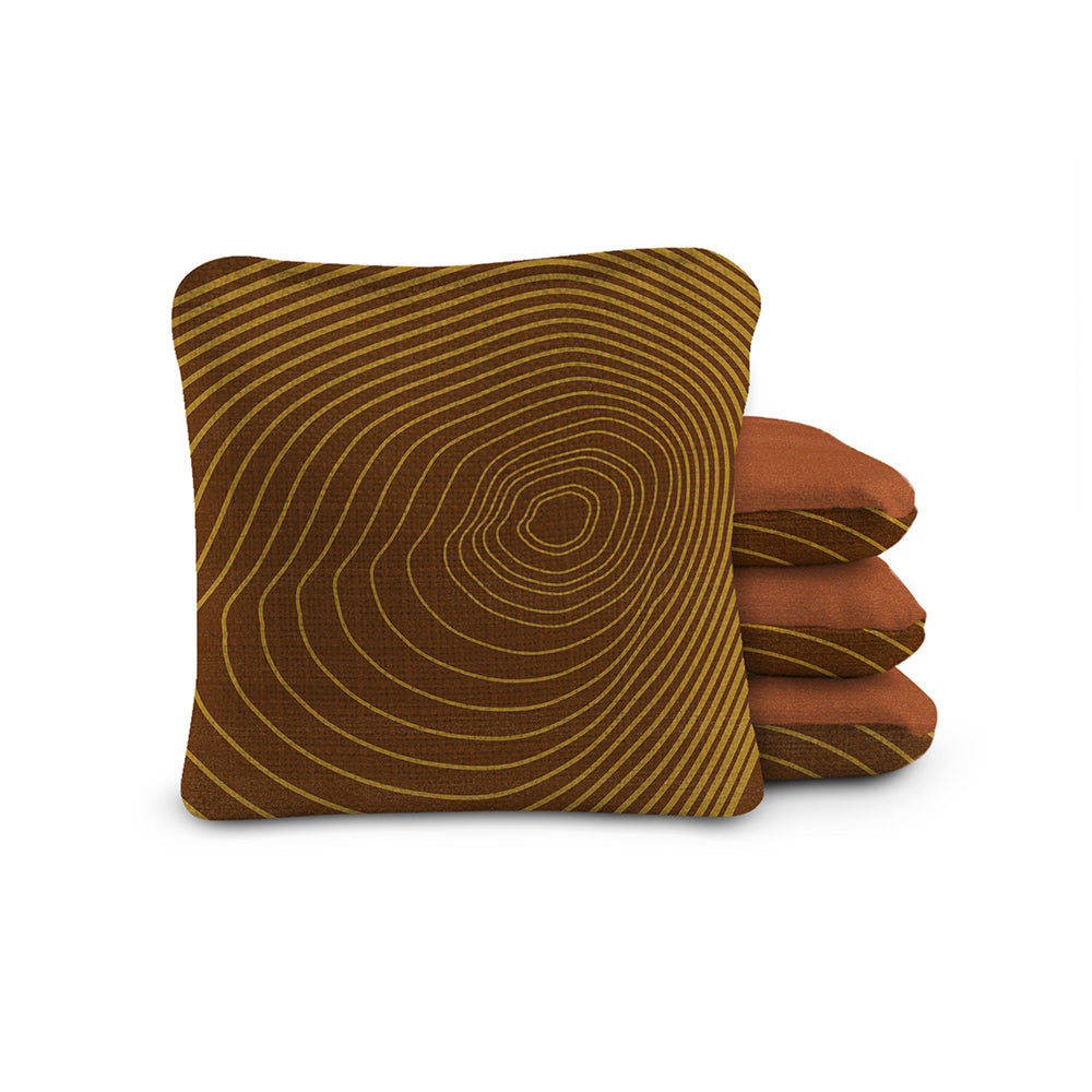 Brown textured pillow with concentric circle pattern on a white background