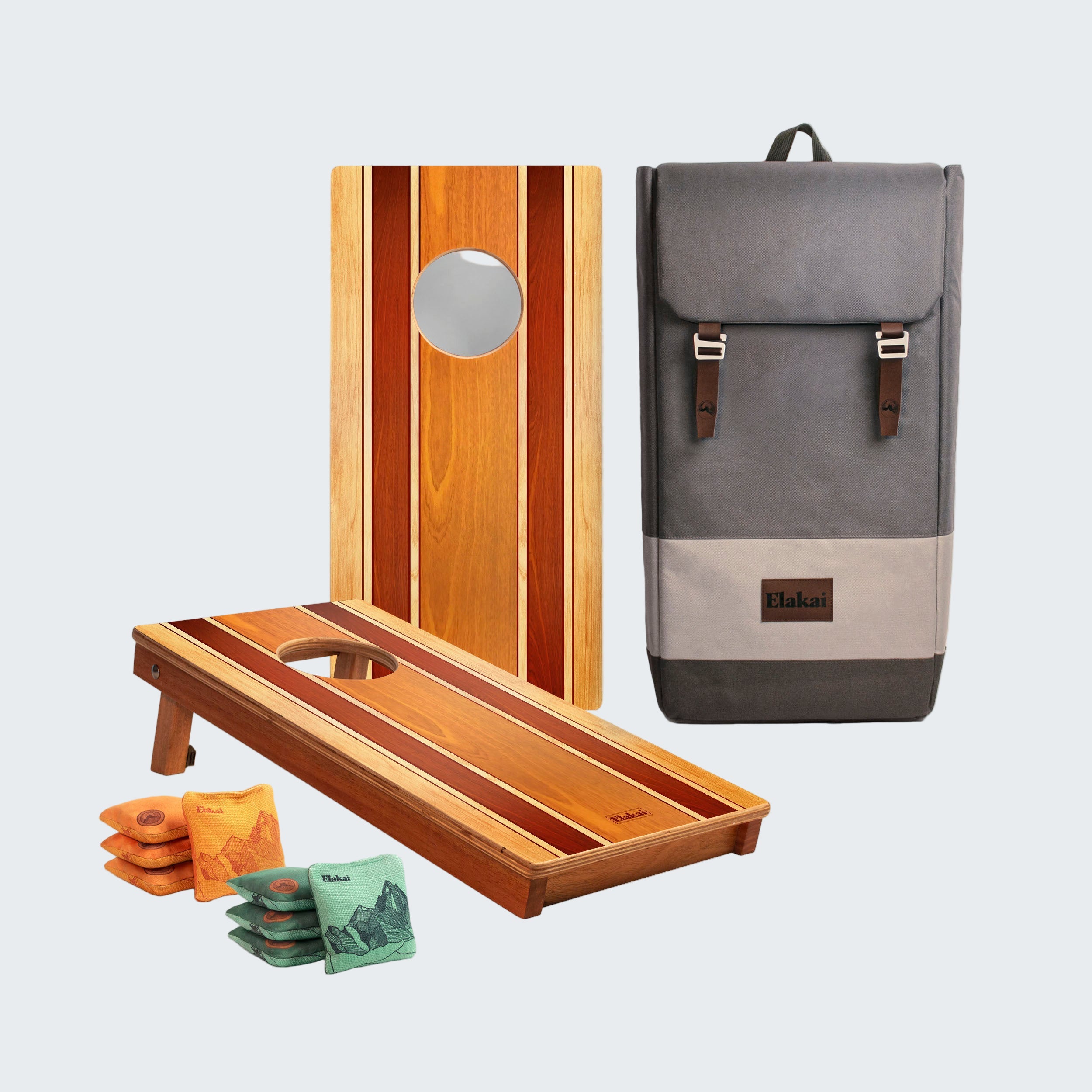 Cornhole boards, bags, and a backpack on a white background