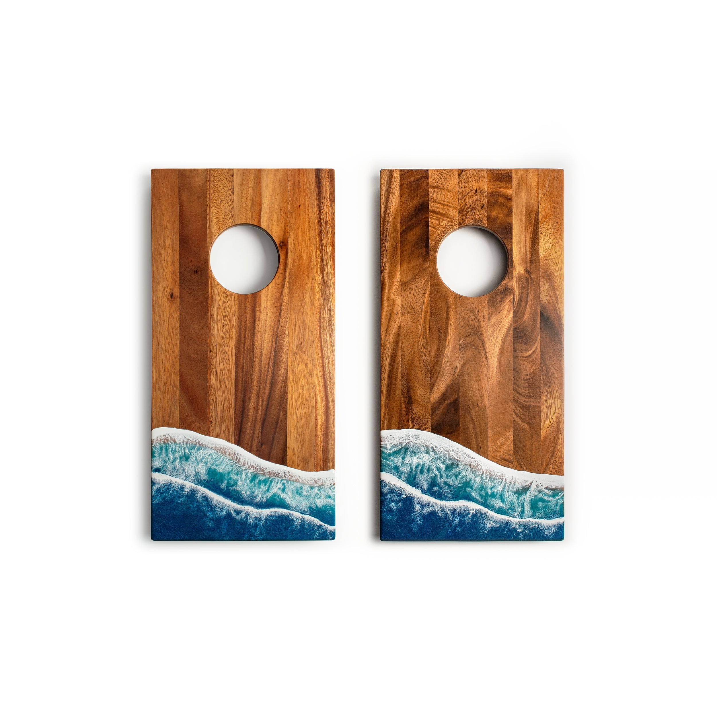 Two wooden cornhole boards with ocean wave design on a white background