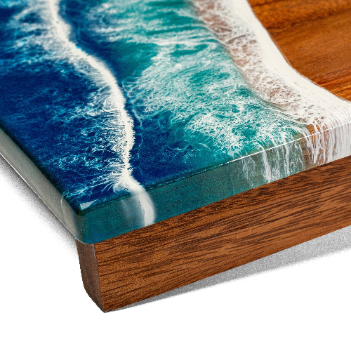 Wooden surface with a resin-embedded design resembling ocean waves.