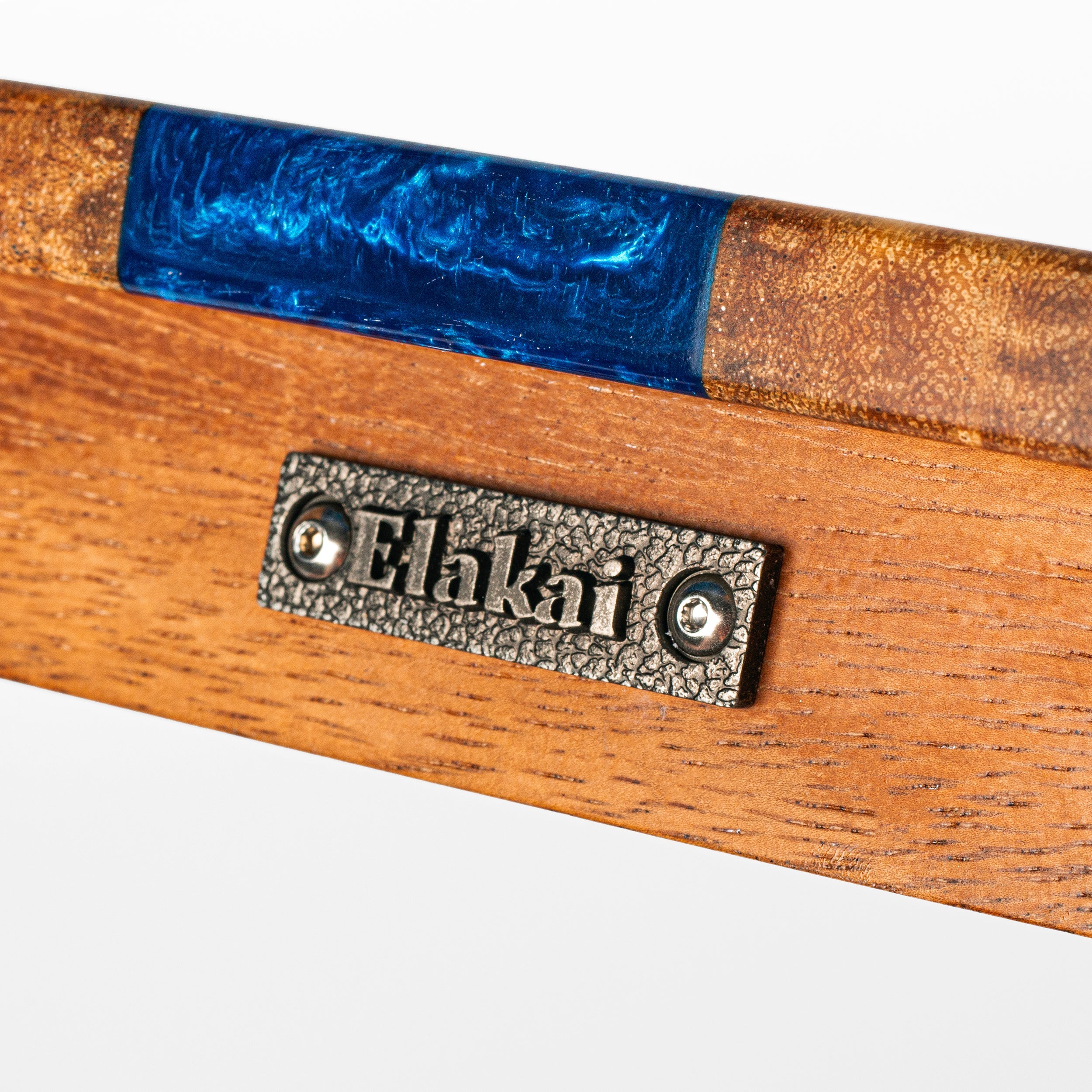 Wooden product with blue resin inlay and 'Elakai' branding on a white background