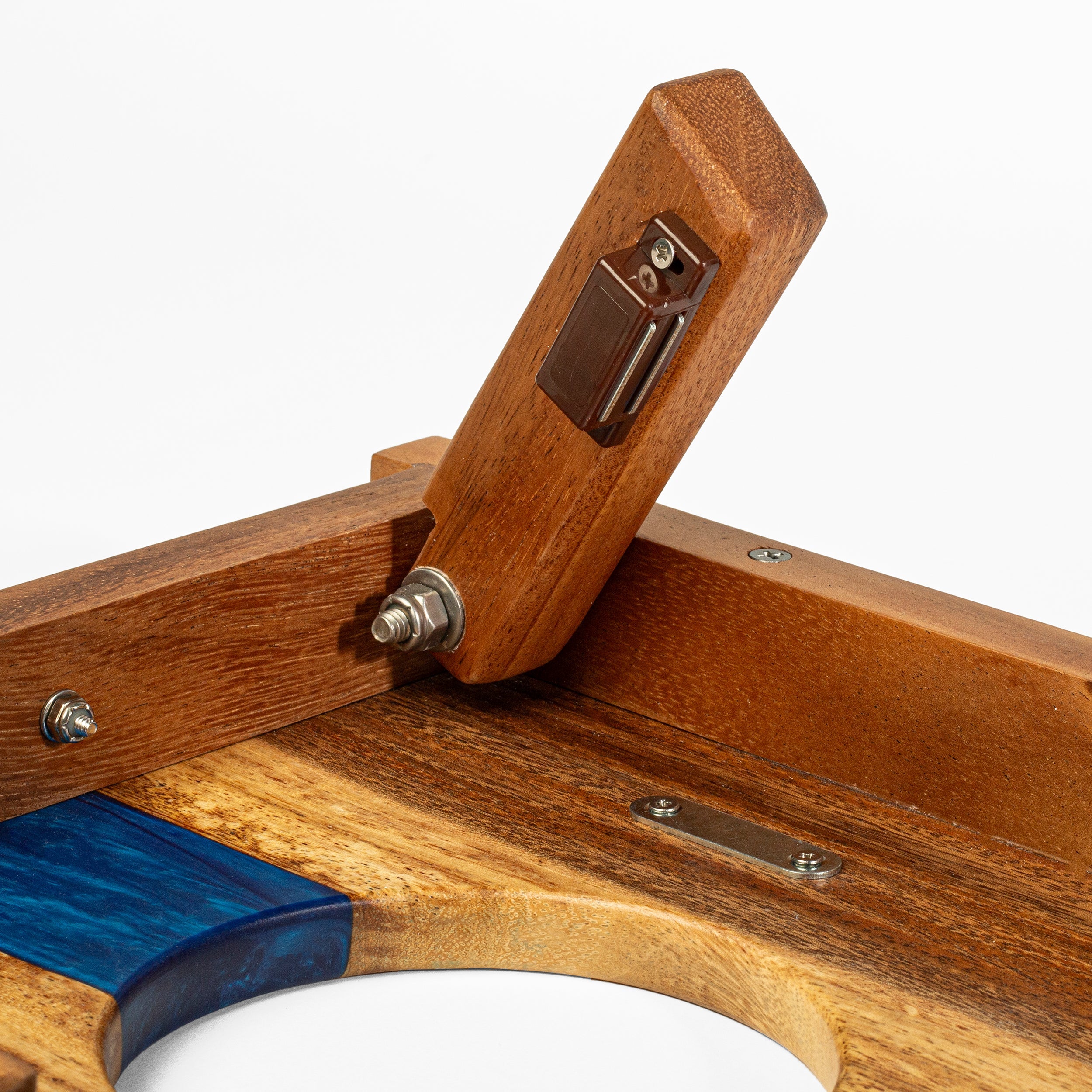 Close-up of a wooden tool with blue handle on a white background