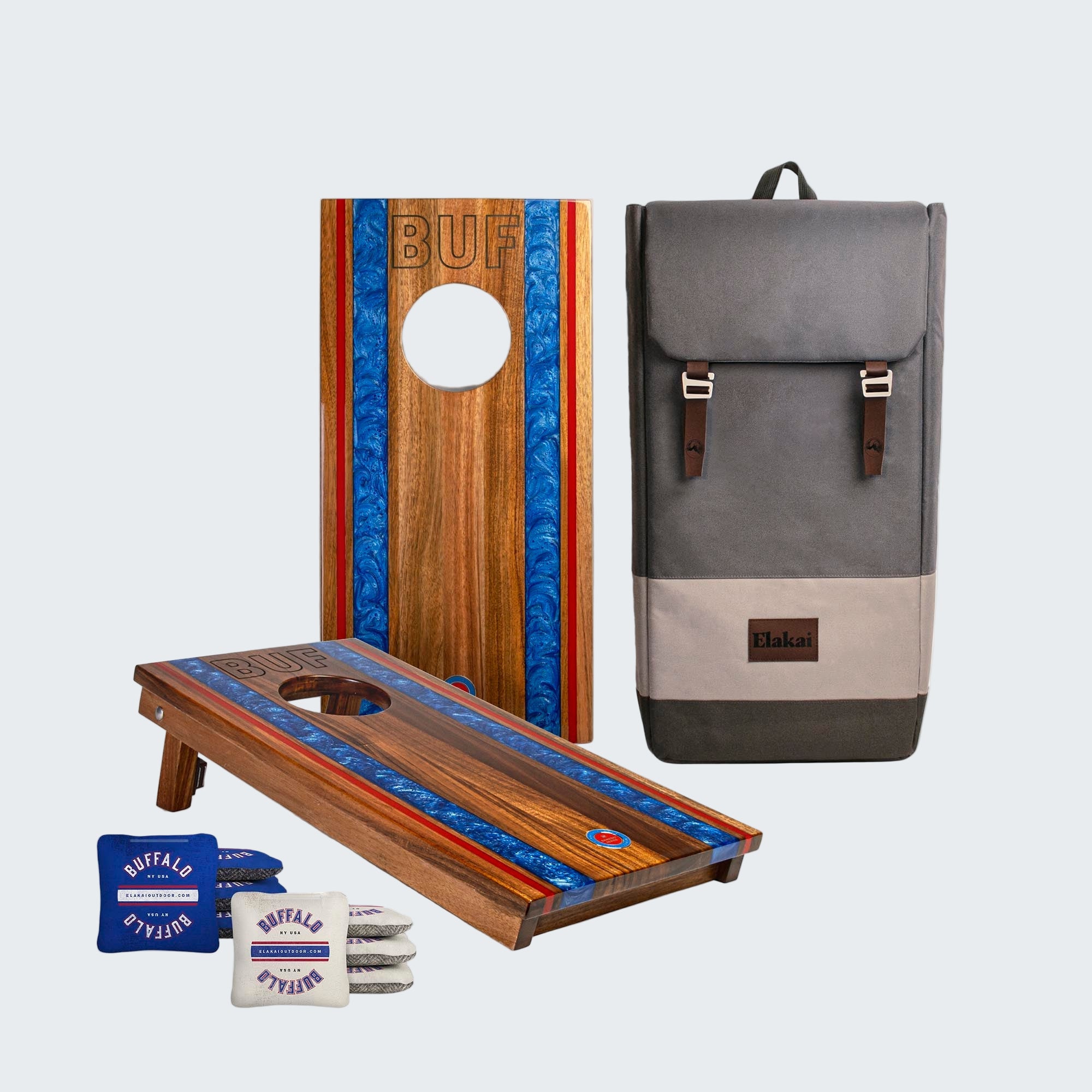 Two wooden cornhole boards with blue and red stripes, a gray backpack, and small bags on a white background.