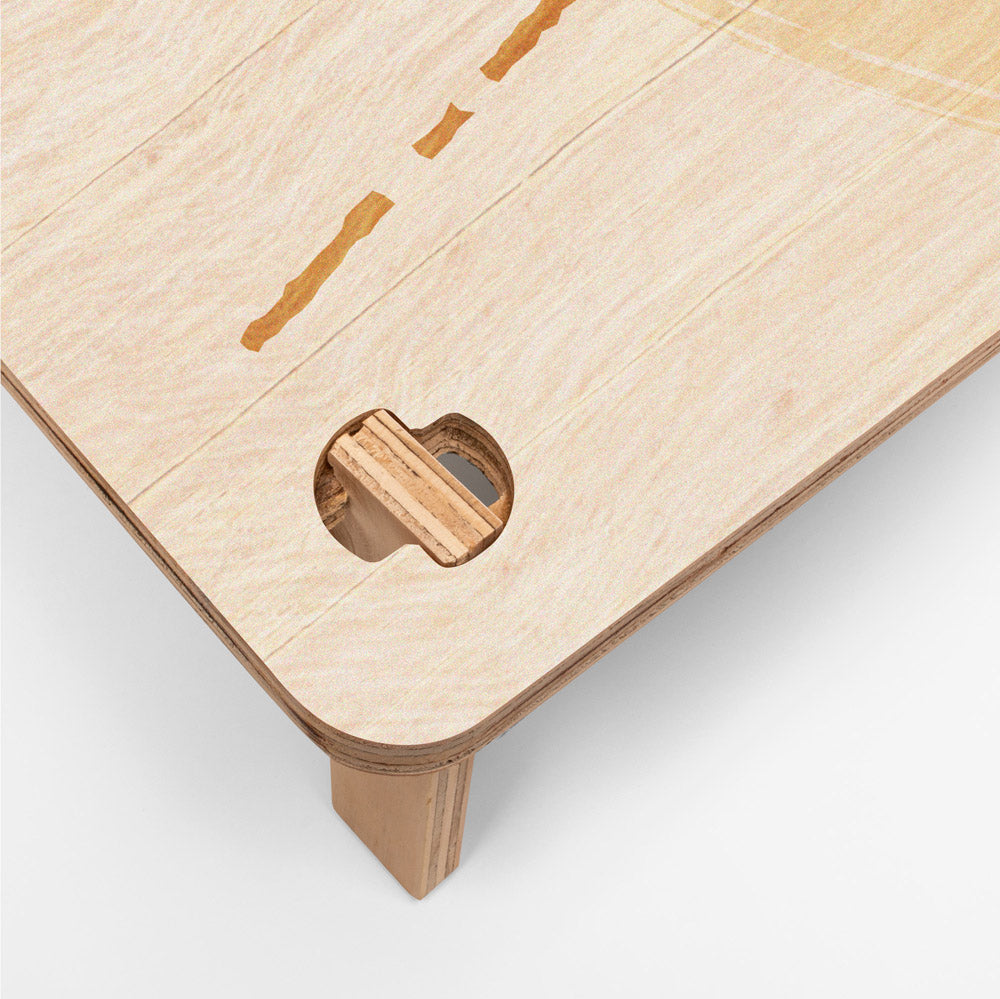 Close-up of a wooden surface with a cut-out design on a white background