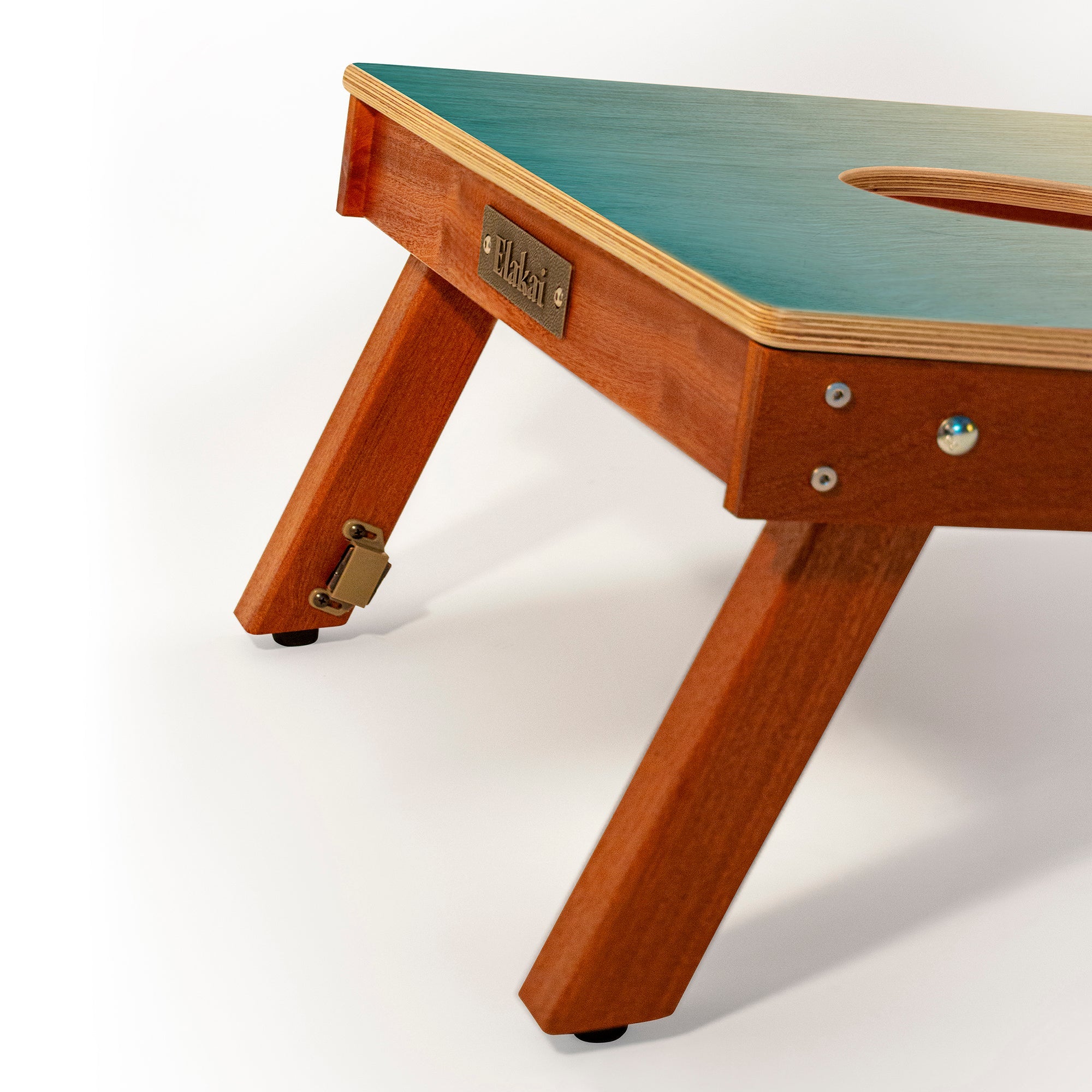 Wooden table with green top on a white background