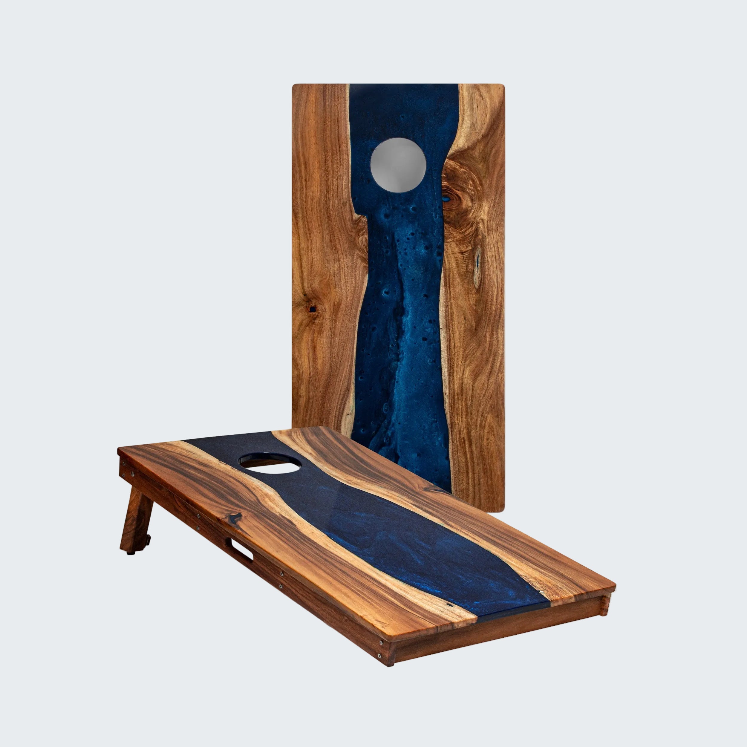 Wooden cornhole boards with blue resin inlay on a white background