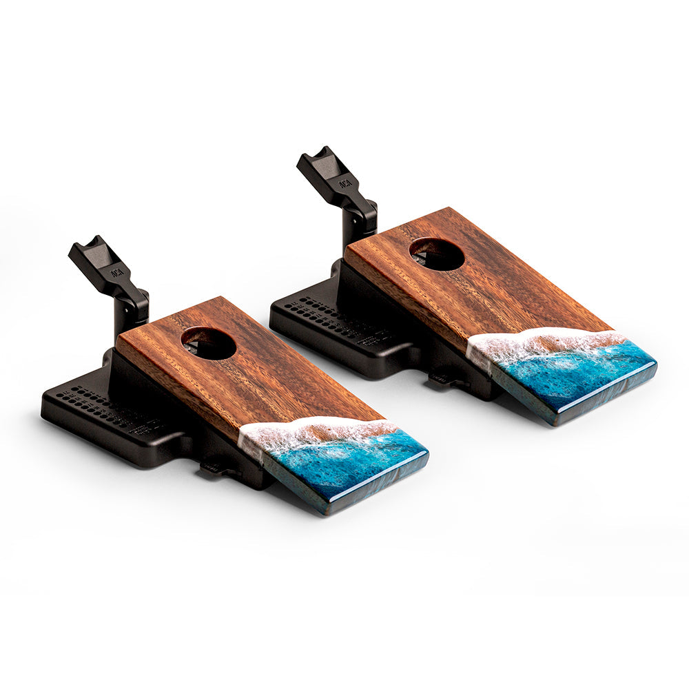 Two wooden boards with black bases and blue wave designs on a white background