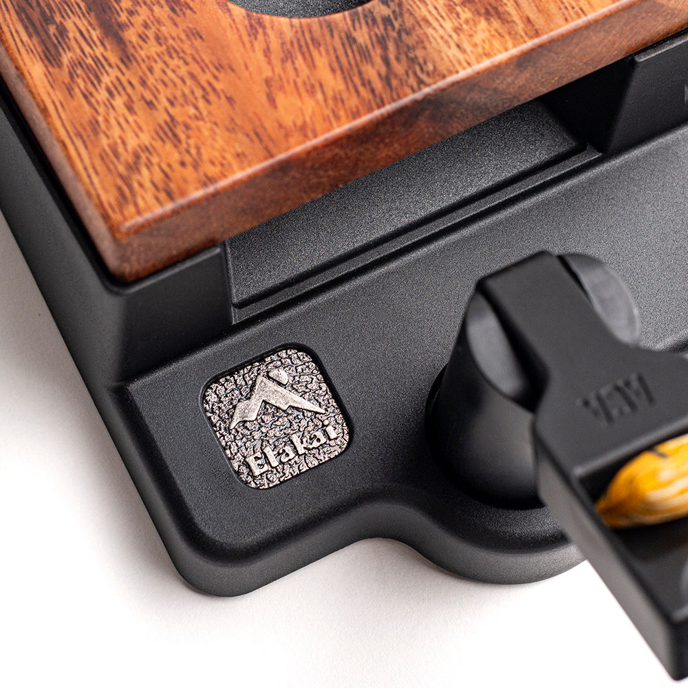 Close-up of a waffle maker with a brand logo on a white background