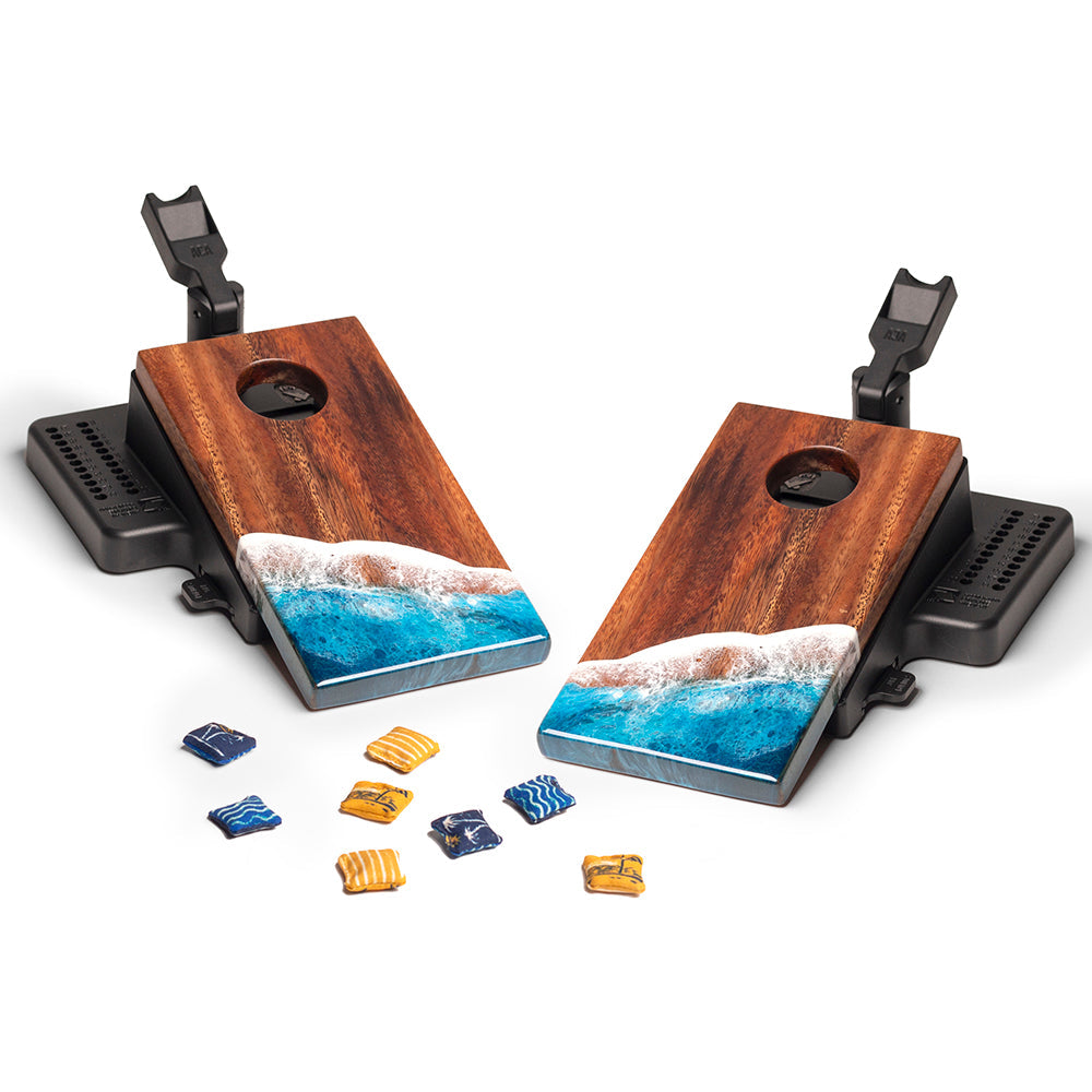 Wooden cornhole boards with ocean design and clips on a white background
