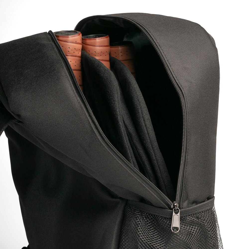 Black backpack with a compartment containing wooden items on a white background