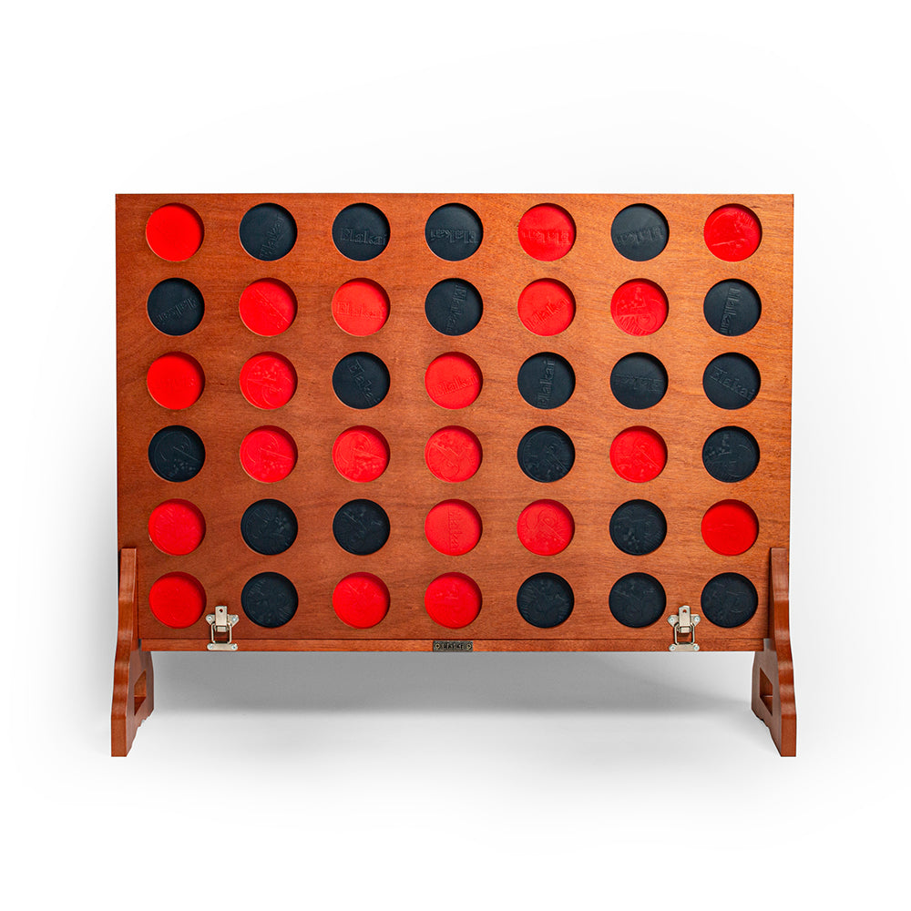 Wooden game board with red and black discs on a white background