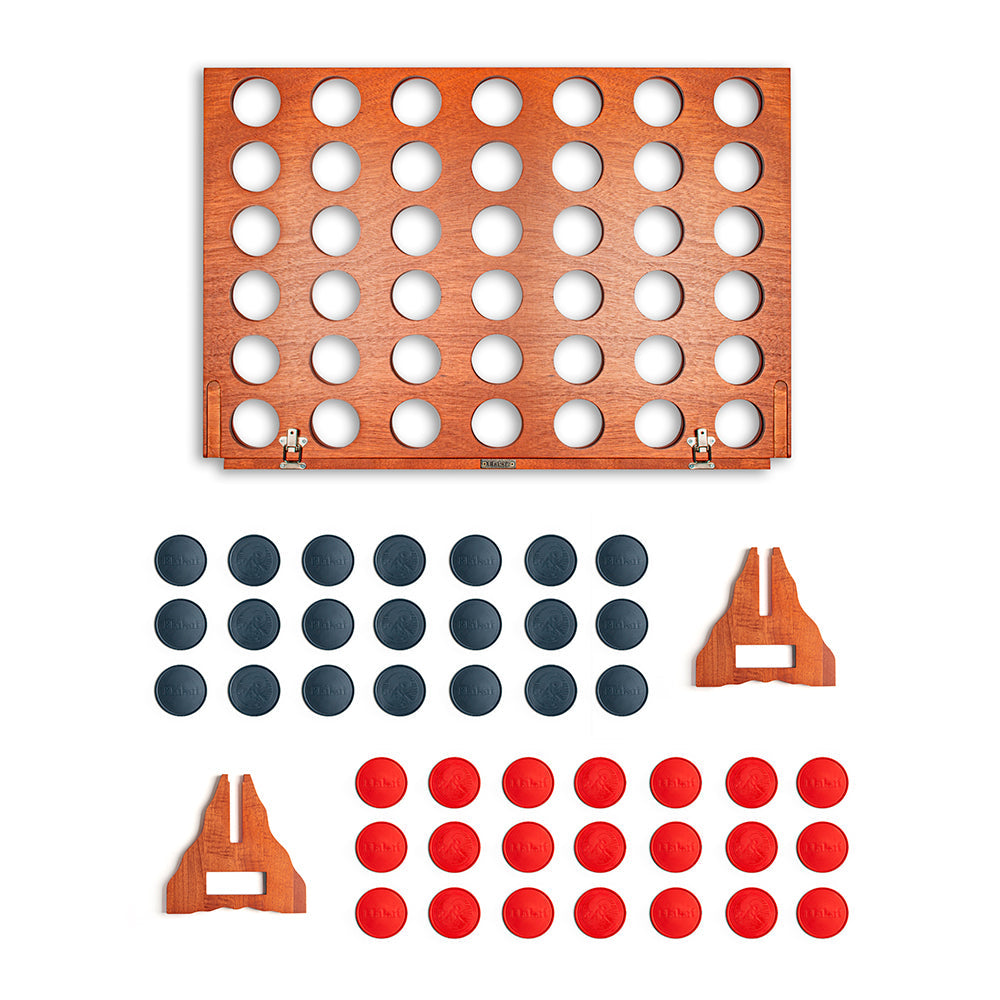 Wooden connect four game set with black and red discs on a white background