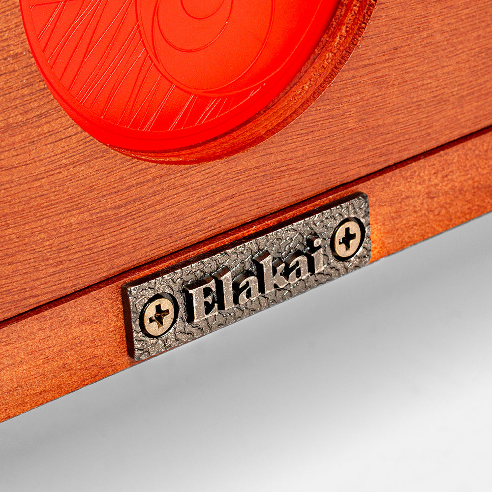 Close-up of a wooden product with a red circular component and 'Elakat' branding.