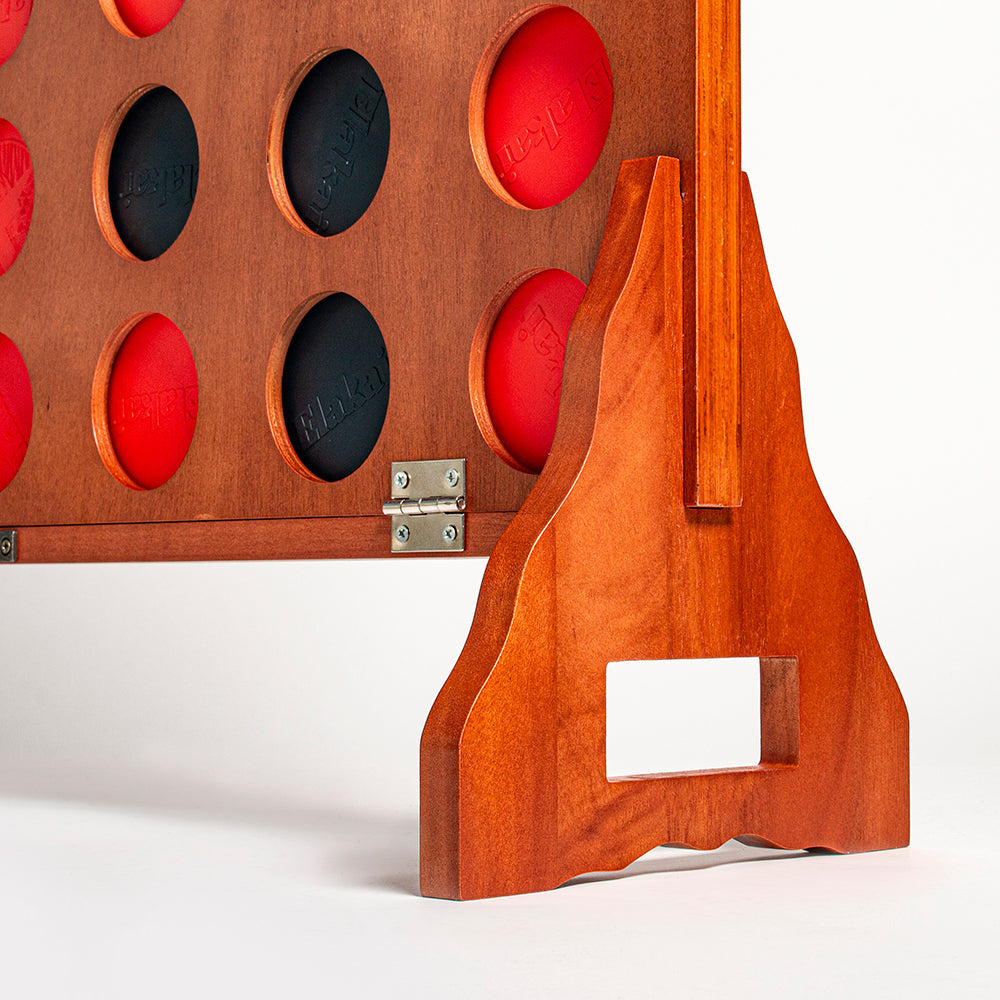 Wooden game board with red and black stones on a white background