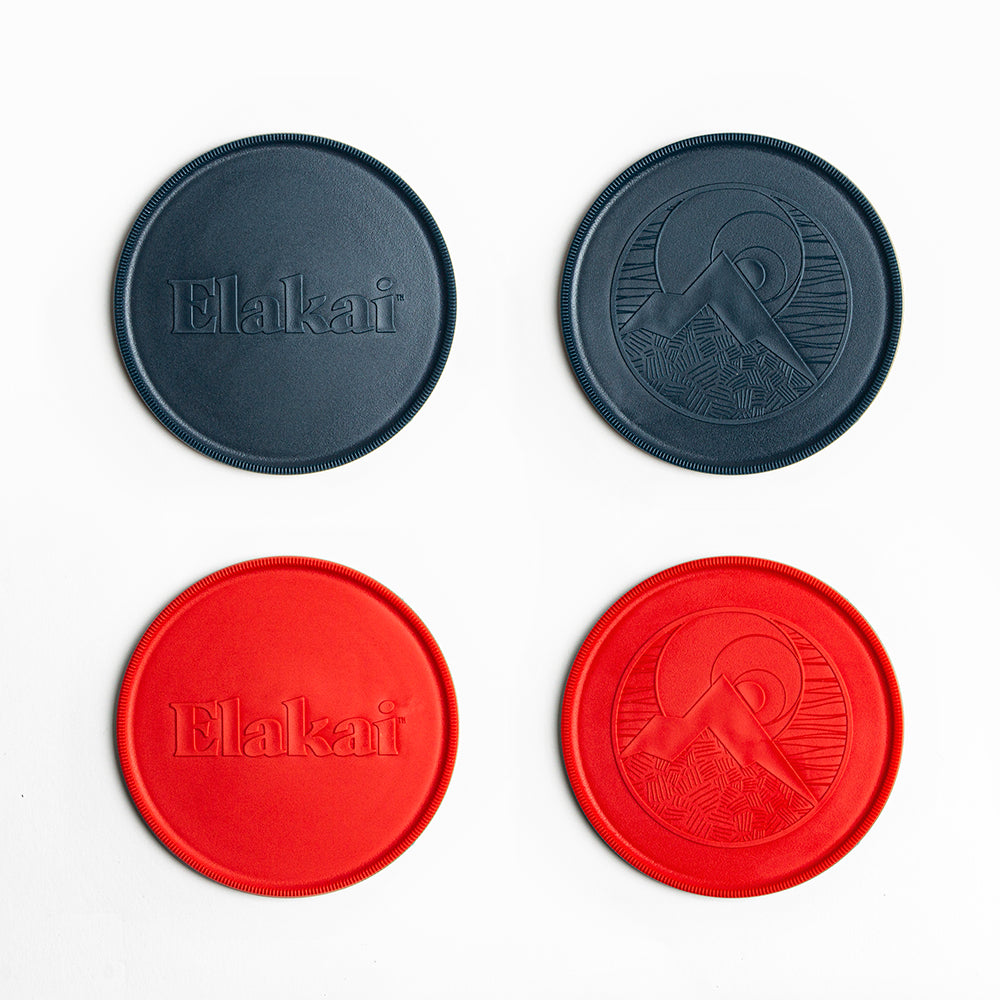 Two black and two red coasters with 'Elakai' branding on a white background
