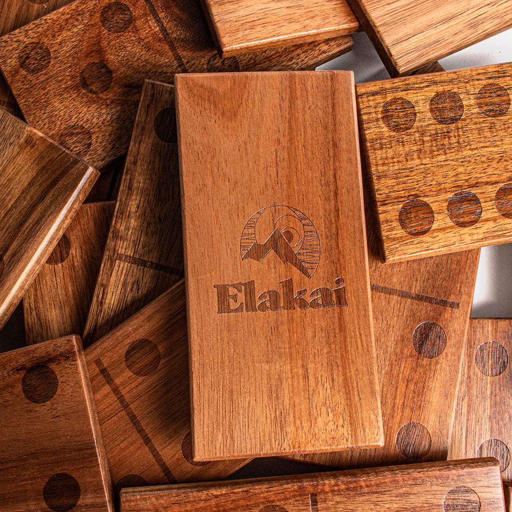 Wooden blocks with 'Elakai' branding on a pile of similar blocks.