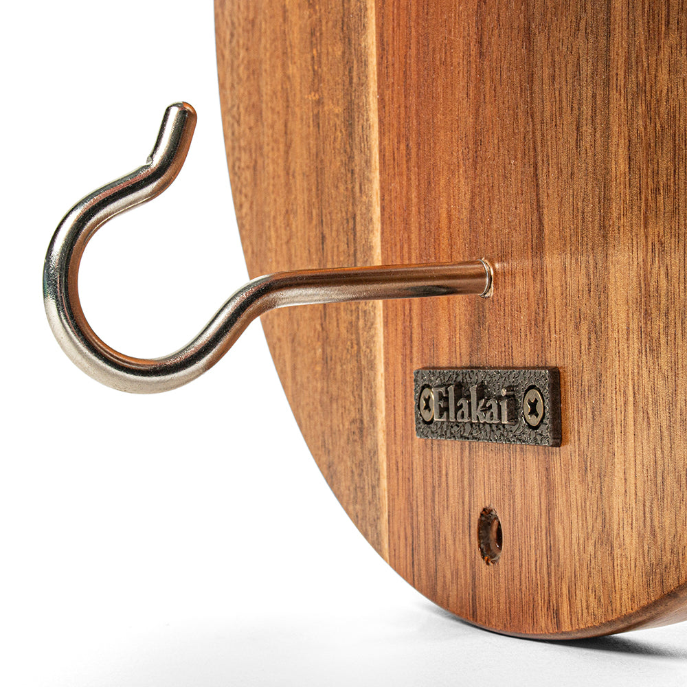 Wooden cutting board with metal hook and 'Elalai' brand logo on a white background