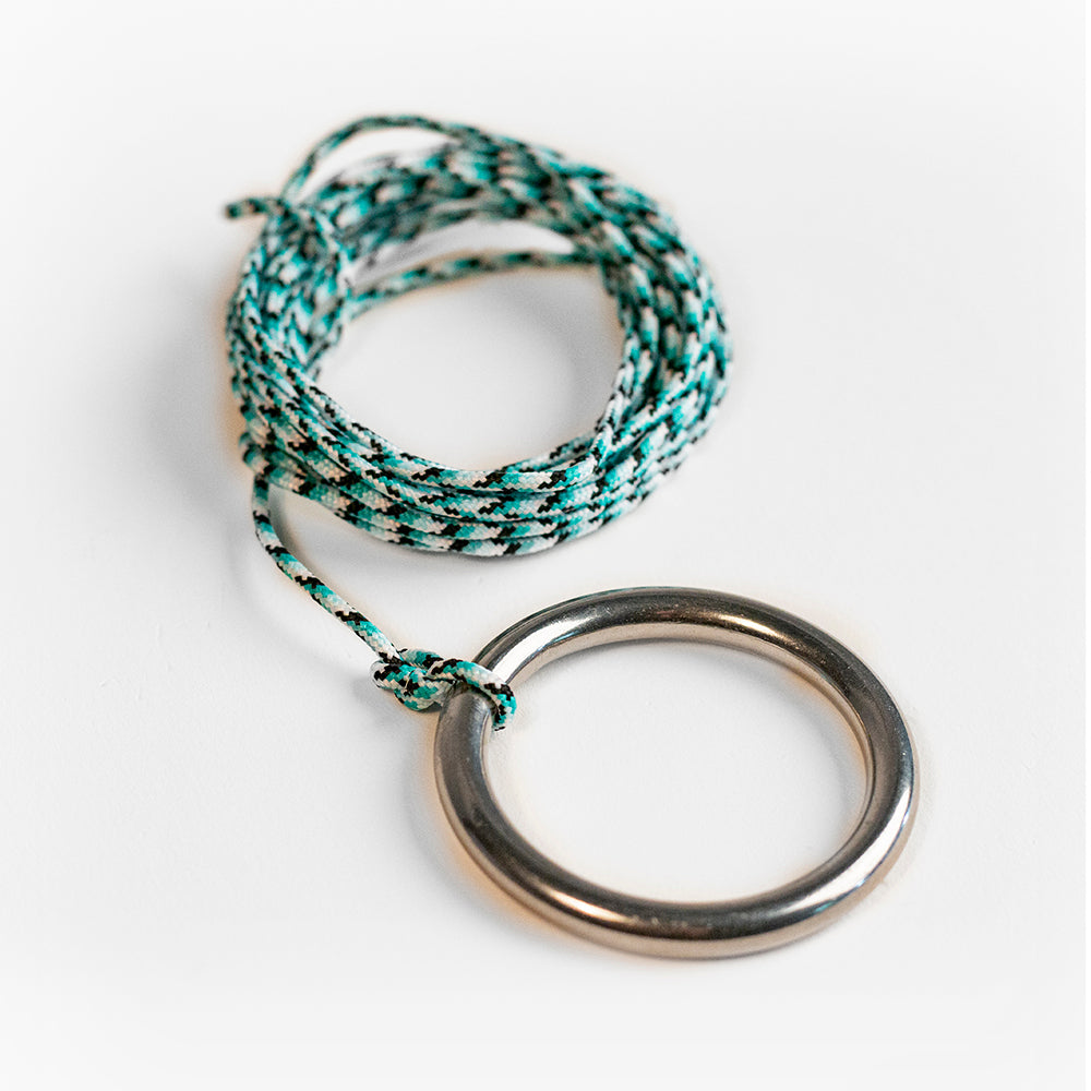 Bracelet with braided design and metal ring on a white background