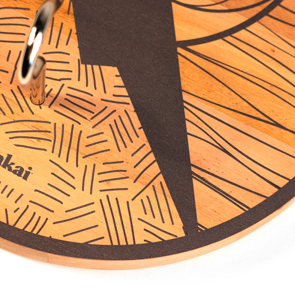 Close-up of a wooden product with black line patterns and 'okai' branding.