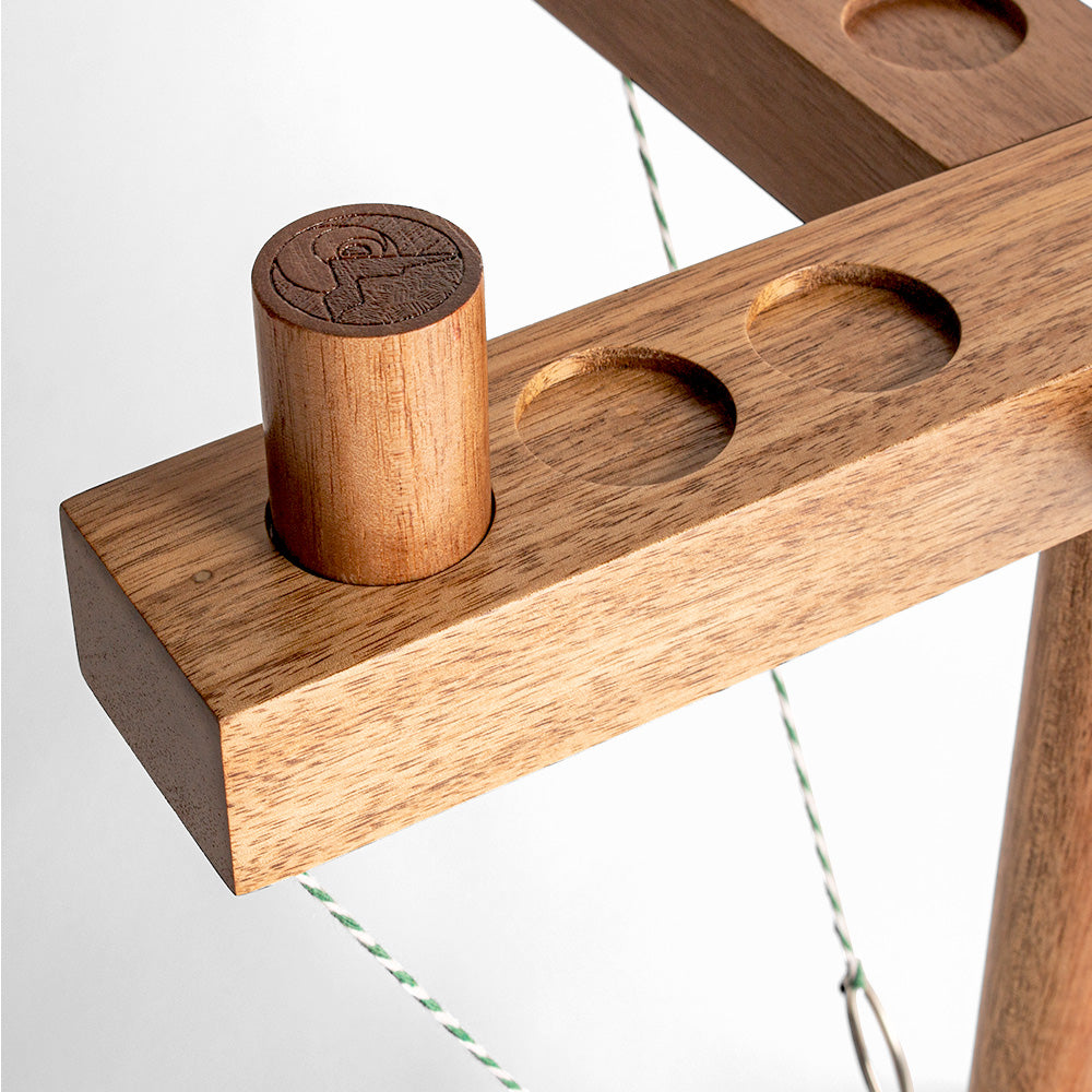 Wooden puzzle with cylindrical piece on a white background