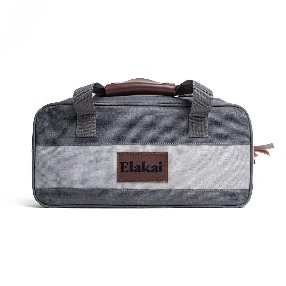 Gray duffel bag with brown handle and Elakai logo on a white background