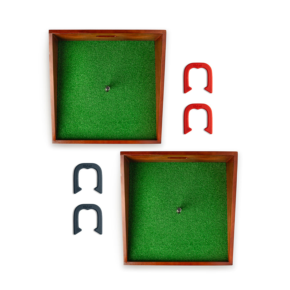 Two wooden frames with green felt and horseshoes on a white background