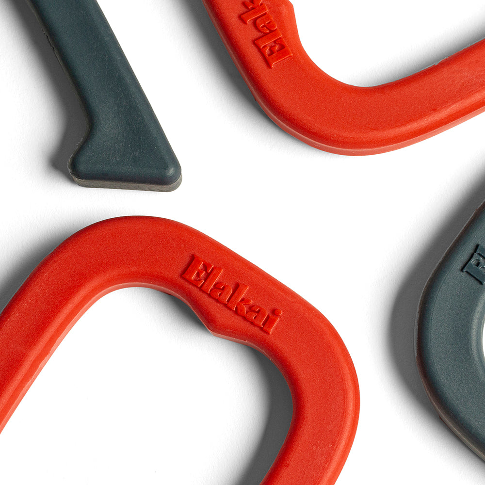 Close-up of red and gray metal hooks with 'Waltari' branding on a white background