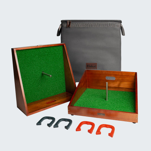 Horseshoe game set with wooden boards, green felt, and horseshoes on a white background.