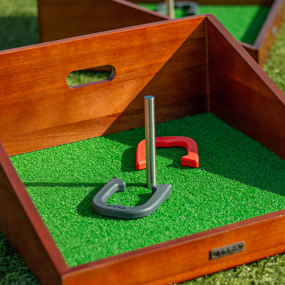 Horseshoe game set with horseshoes on a green playing field