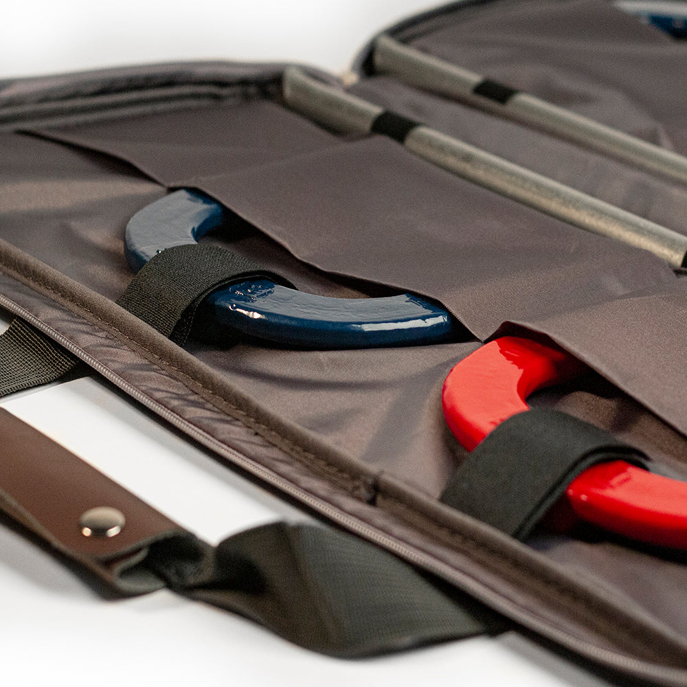 Open briefcase with tools including a blue tool and a red tool on a white background