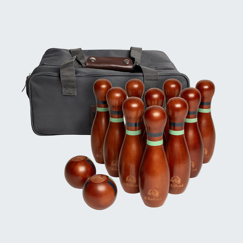 Set of wooden bowling pins and balls with a carrying bag on a white background