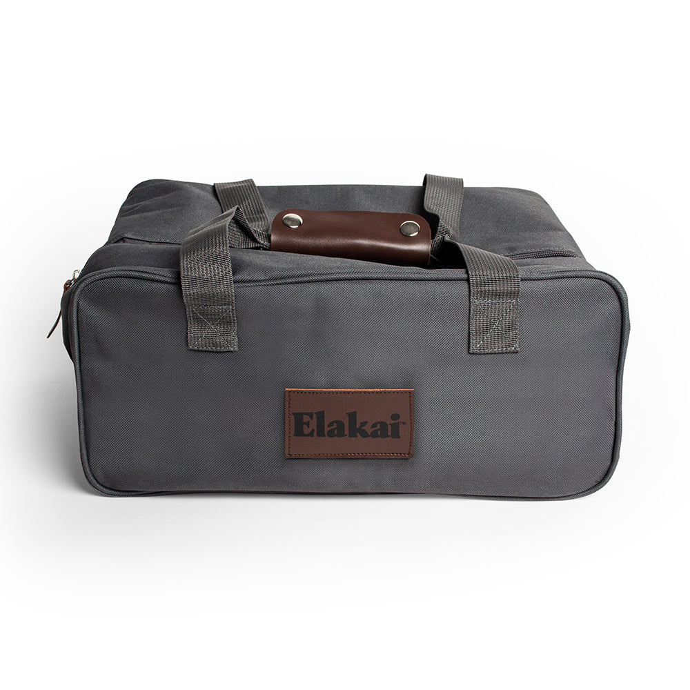 Gray duffel bag with brown leather patch and 'Elakai' branding on a white background
