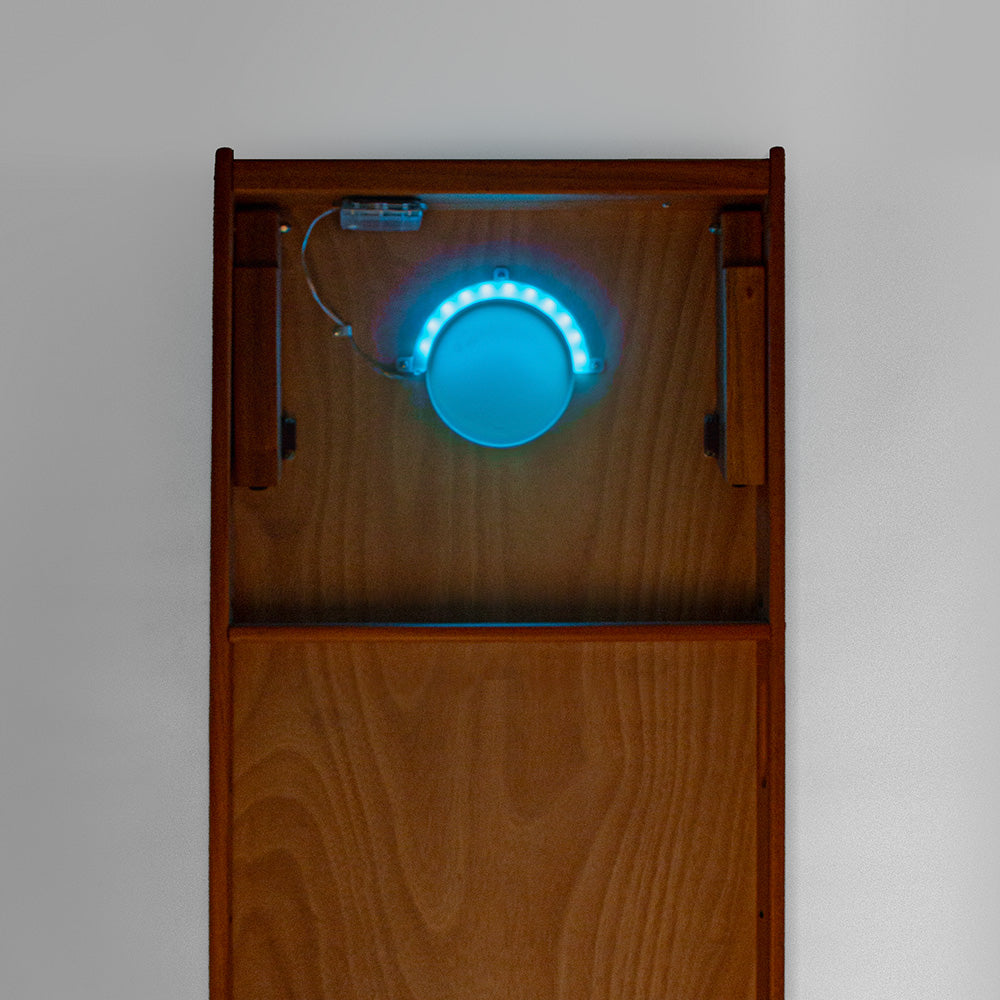 Wooden box with a blue LED light on a gray background