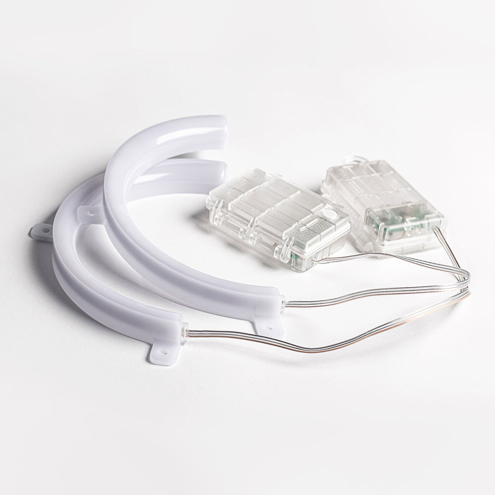 Clear dental tool with a white base on a light gray background