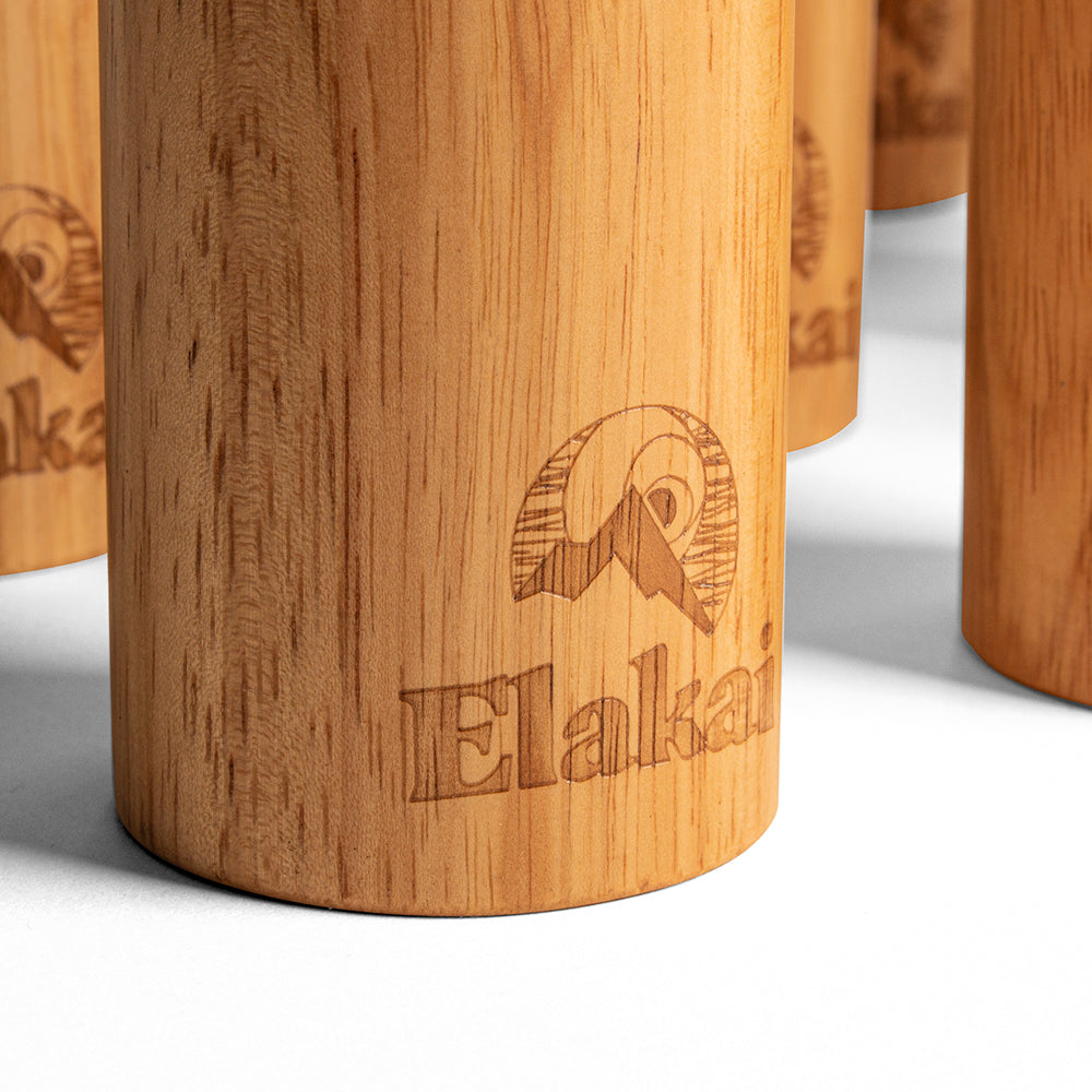 Wooden stools with 'Elakati' branding on a white background