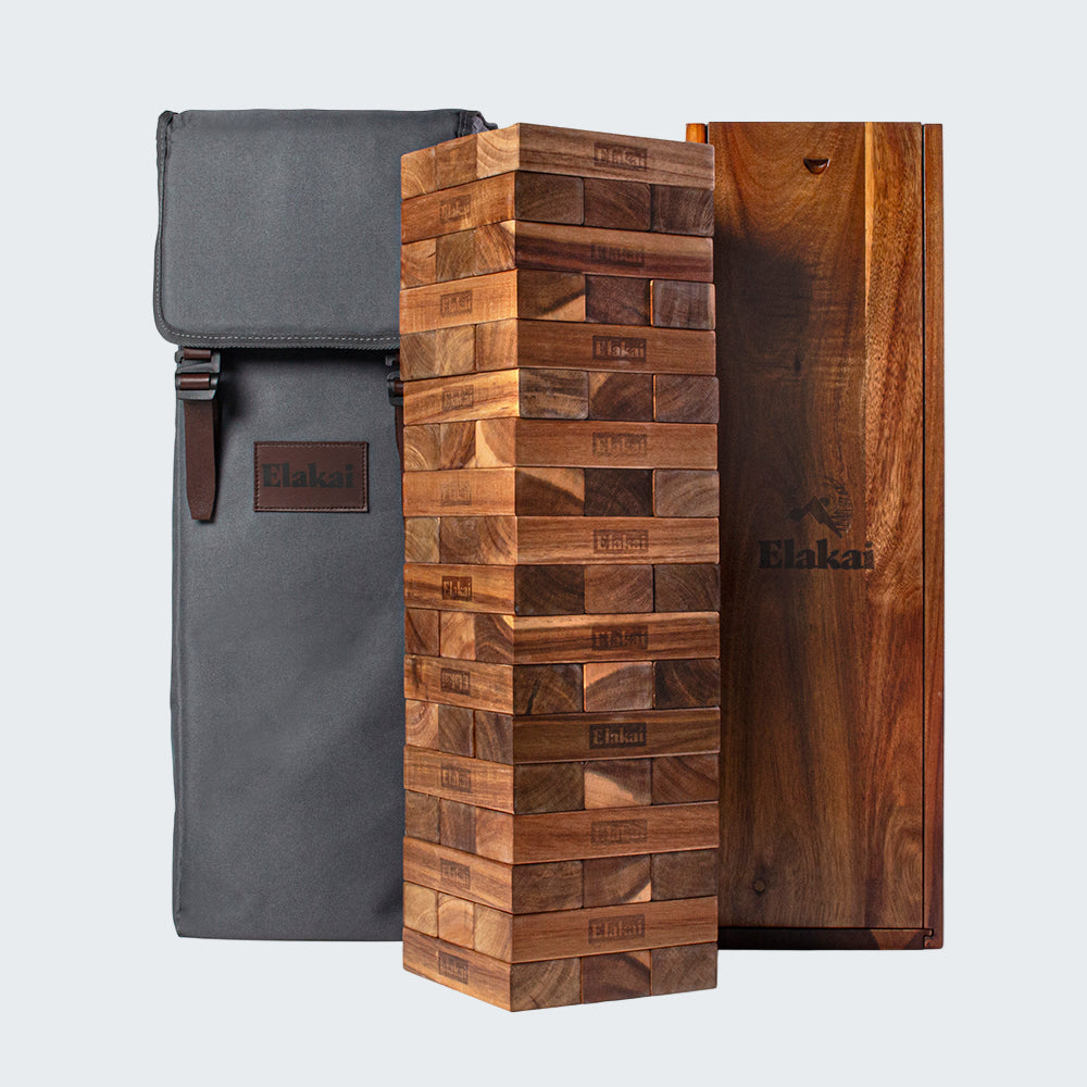 Wooden block tower game with carrying bag on a white background