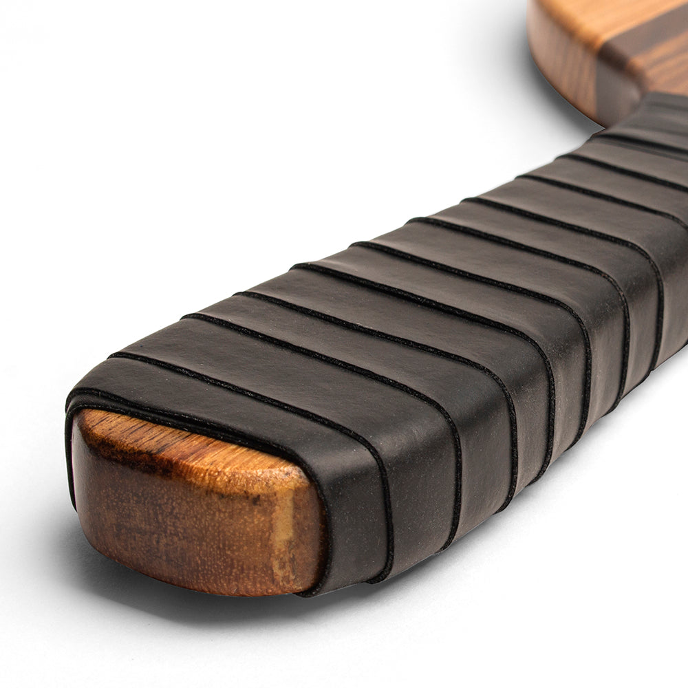 Close-up of a guitar neck with black binding on a white background