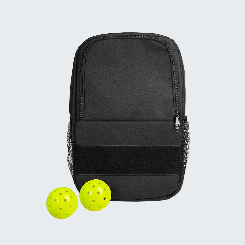 Black backpack with two yellow pickle balls on a white background