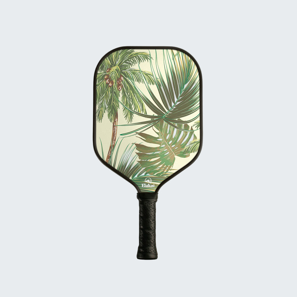 Pickleball paddle with tropical leaf design on a white background