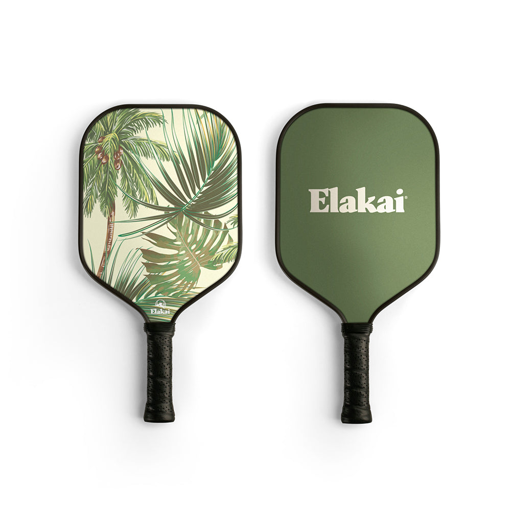 Two pickleball paddles, one with a palm leaf design and the other with 'Elakai' branding, on a white background.