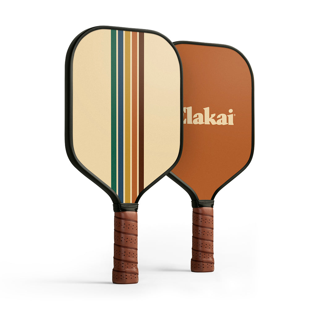 Two pickleball paddles with striped design and brown handles on a white background